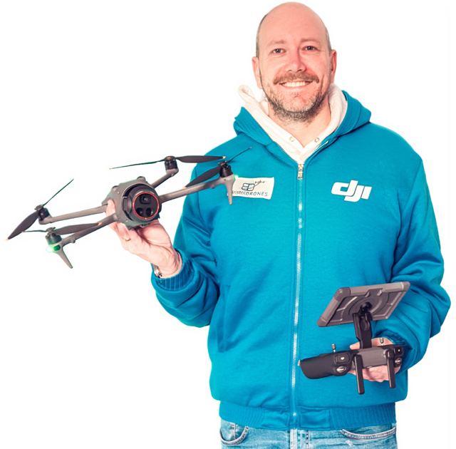 Portrait of Philippe Francken wearing a Bristol Drones branded fleece holding a DJI Mavic 4 Pro drone and the DJI RC Pro 2 controller.