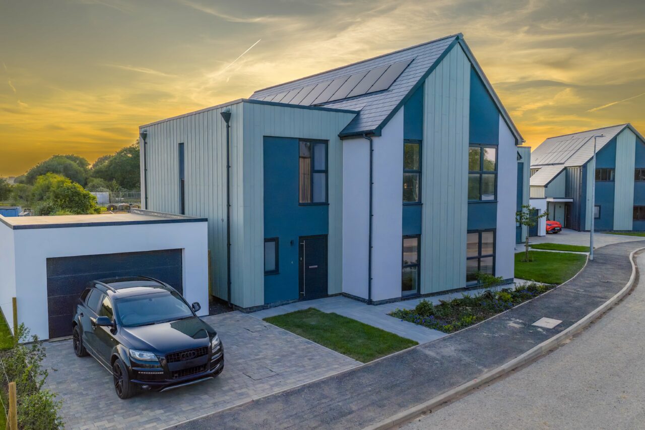 An elevated shot of a property at a property development site in Rangeworthy, South Gloucestershire during golden hour in June 2025, with the sunlight hitting the back of the building.